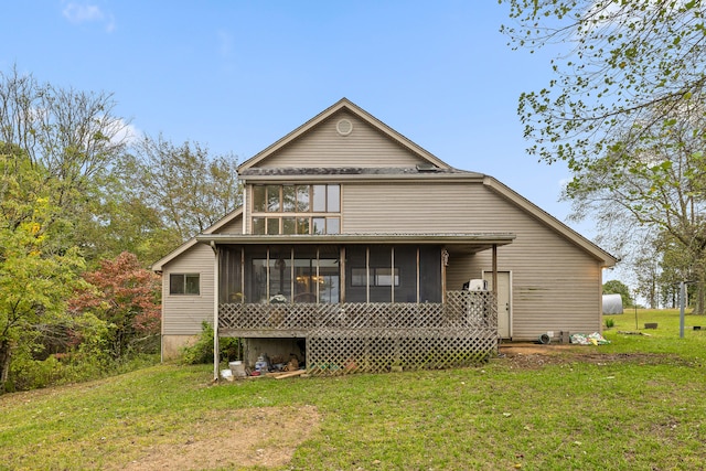 back of property featuring a sunroom and a lawn