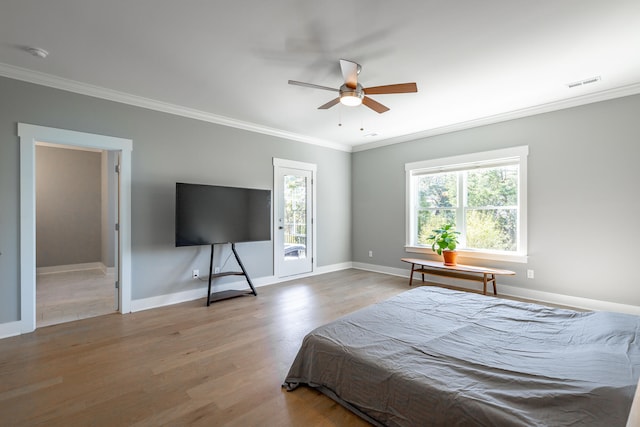 bedroom featuring crown molding, hardwood / wood-style floors, and ceiling fan