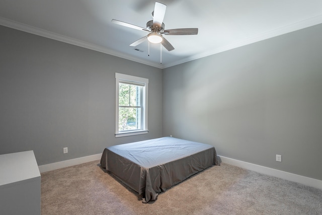 carpeted bedroom featuring crown molding and ceiling fan