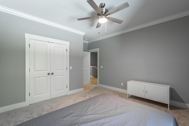 unfurnished bedroom featuring light carpet, crown molding, a closet, and ceiling fan