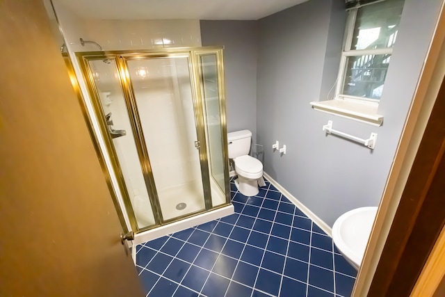 bathroom with tile patterned flooring, toilet, and a shower with shower door