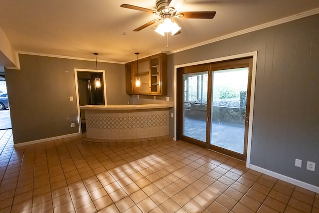 kitchen featuring ceiling fan, hanging light fixtures, ornamental molding, and light tile patterned flooring