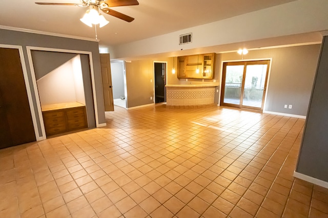 unfurnished living room featuring ceiling fan, light tile patterned flooring, and ornamental molding