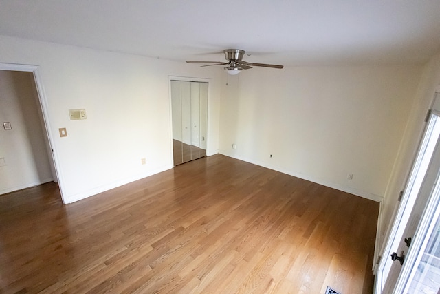 empty room with ceiling fan and wood-type flooring