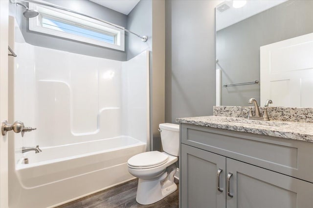 full bathroom with vanity, toilet, hardwood / wood-style flooring, and shower / bathtub combination