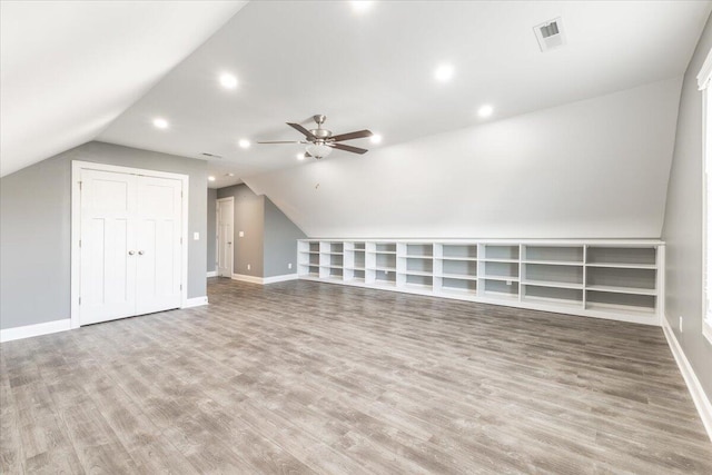 bonus room with ceiling fan, wood-type flooring, and vaulted ceiling