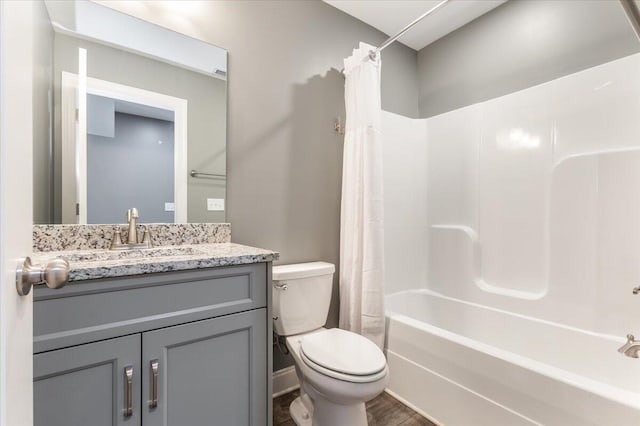 full bathroom with vanity, hardwood / wood-style floors, shower / bath combination with curtain, and toilet