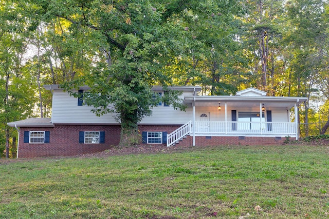 tri-level home with a front yard and a porch