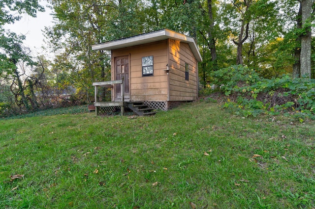 view of outdoor structure featuring a lawn