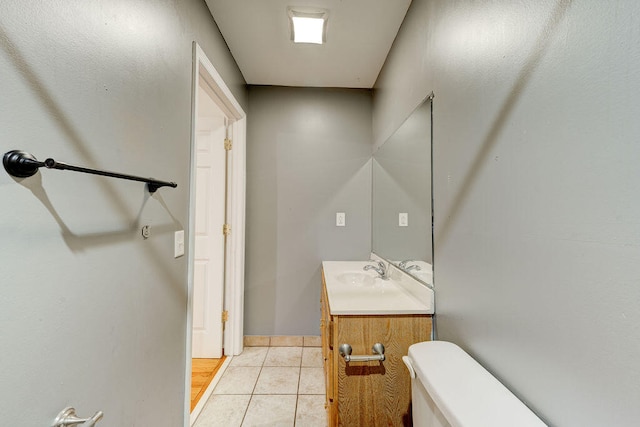 bathroom with vanity, toilet, and tile patterned flooring