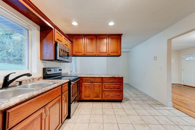 kitchen featuring light hardwood / wood-style flooring, black range with electric stovetop, and sink