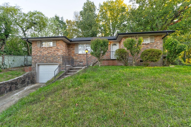 view of front of property featuring a garage and a front lawn