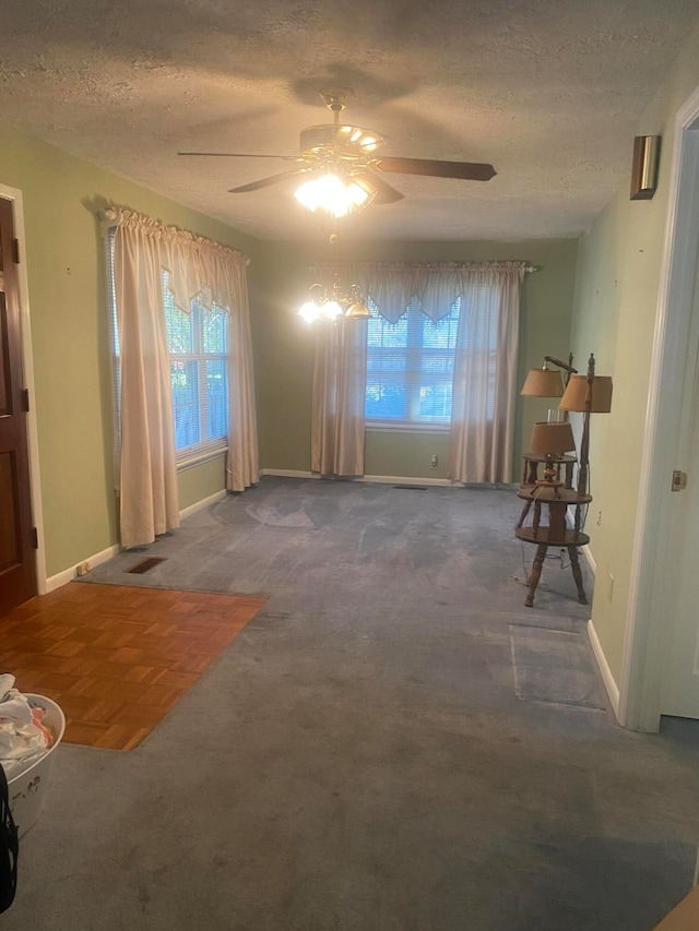 interior space with ceiling fan and a textured ceiling