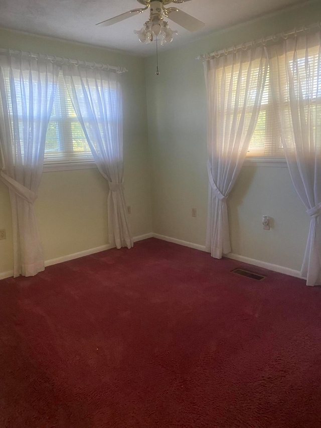 carpeted empty room featuring ceiling fan