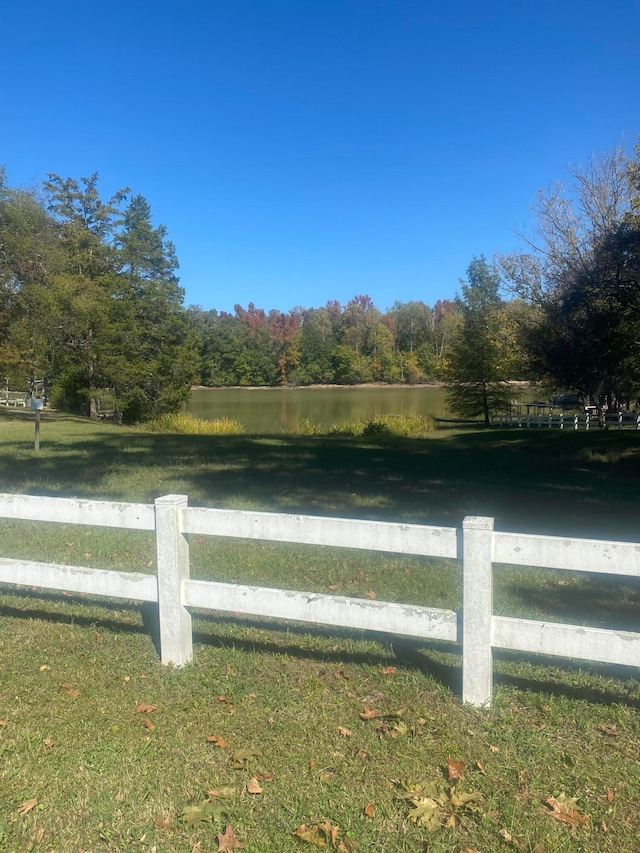 view of yard with a rural view and a water view