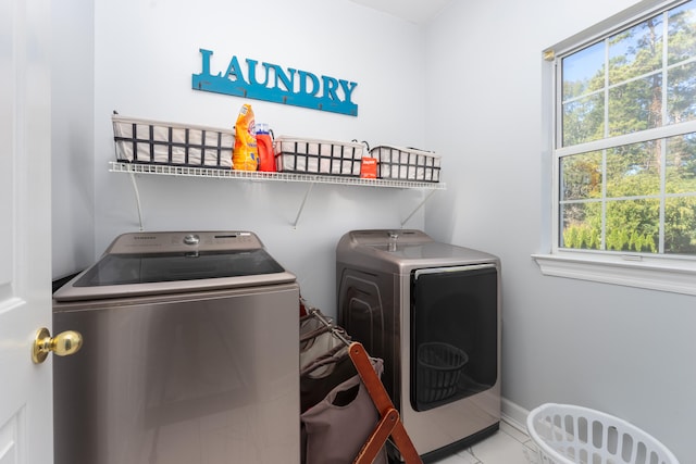 washroom featuring light tile patterned floors and washing machine and clothes dryer