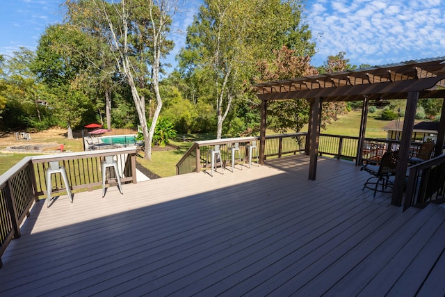 deck with a pool and a pergola