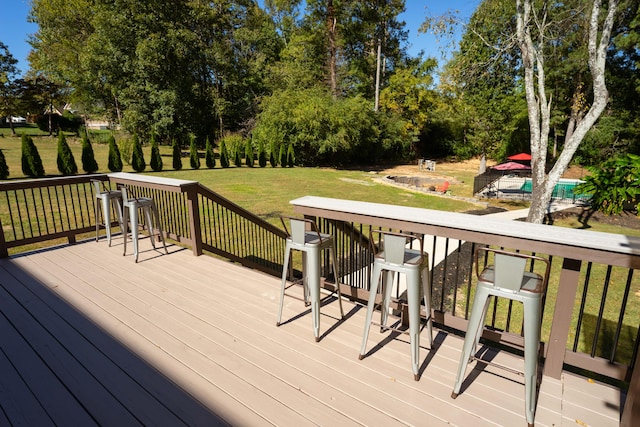 wooden terrace featuring a yard and a swimming pool