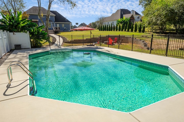 view of swimming pool with a yard and a patio