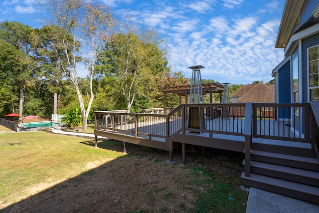 wooden deck featuring a pergola and a yard