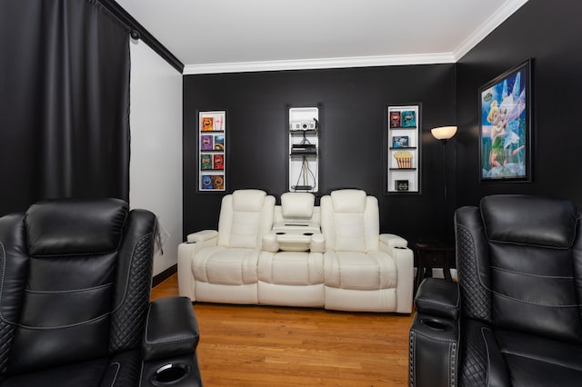 cinema featuring ornamental molding and hardwood / wood-style flooring