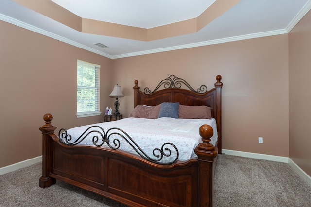 carpeted bedroom featuring crown molding and a raised ceiling