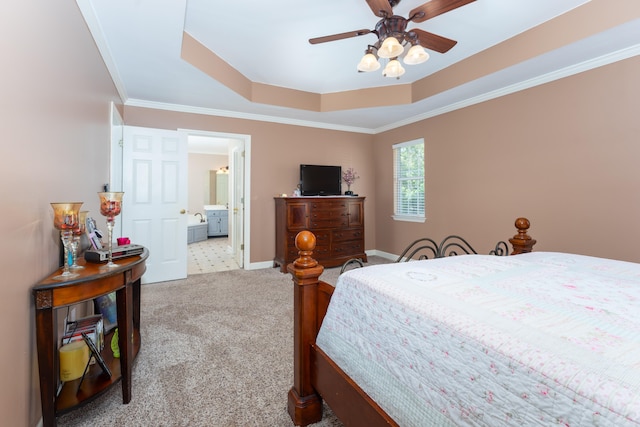 bedroom featuring ensuite bathroom, a raised ceiling, ceiling fan, light carpet, and crown molding