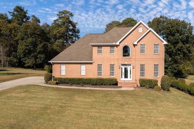 colonial-style house with a front lawn