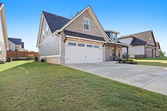 view of front of home featuring central AC unit, a garage, and a front lawn