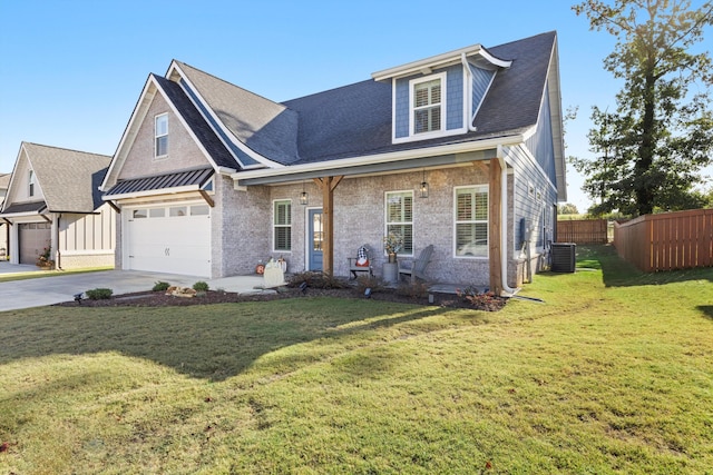 view of front facade with a front yard, cooling unit, and a garage