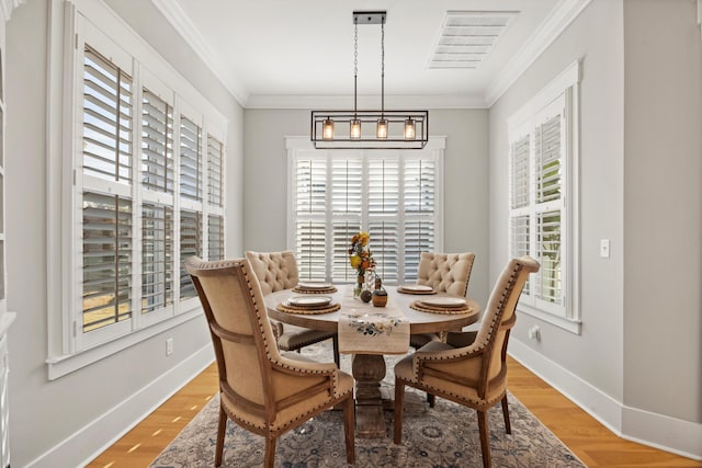 dining room with crown molding and a wealth of natural light