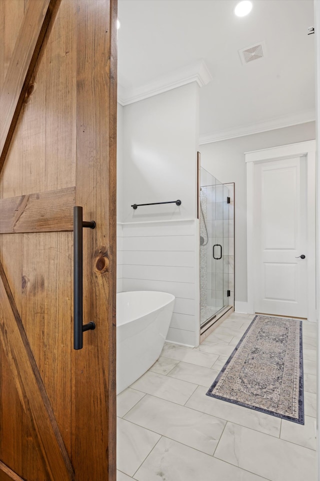 bathroom with crown molding and independent shower and bath