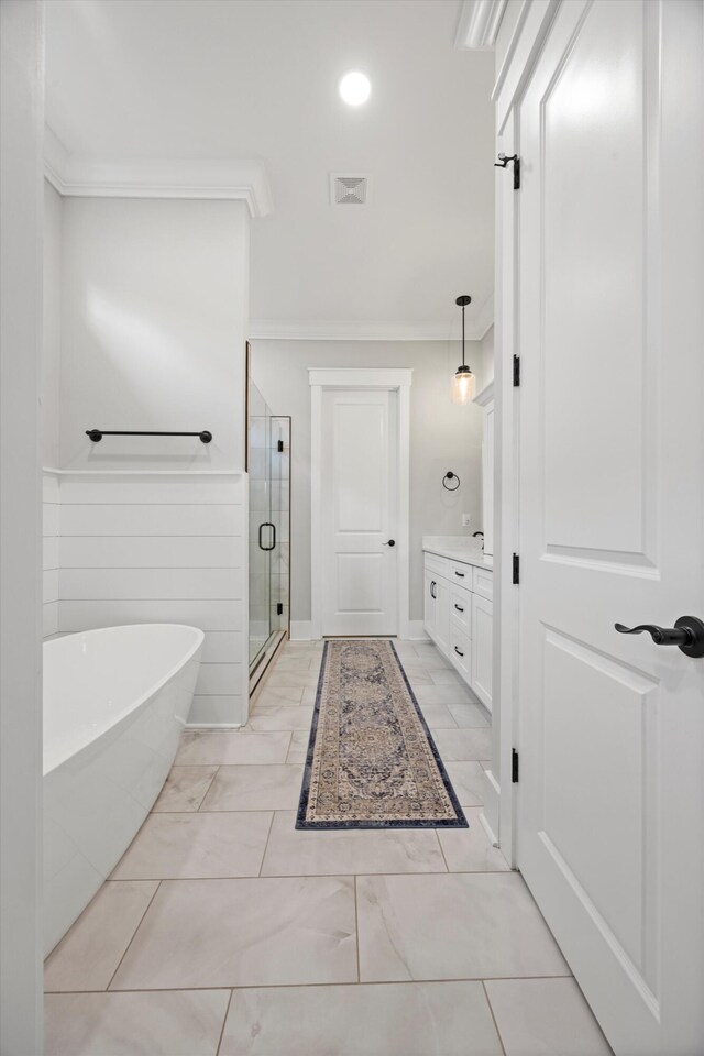 bathroom with vanity, crown molding, and independent shower and bath