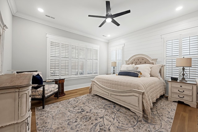 bedroom with ceiling fan, ornamental molding, and light hardwood / wood-style flooring