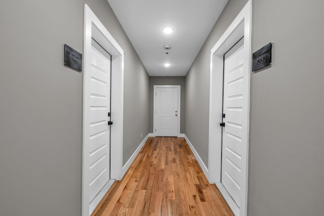 corridor with hardwood / wood-style floors