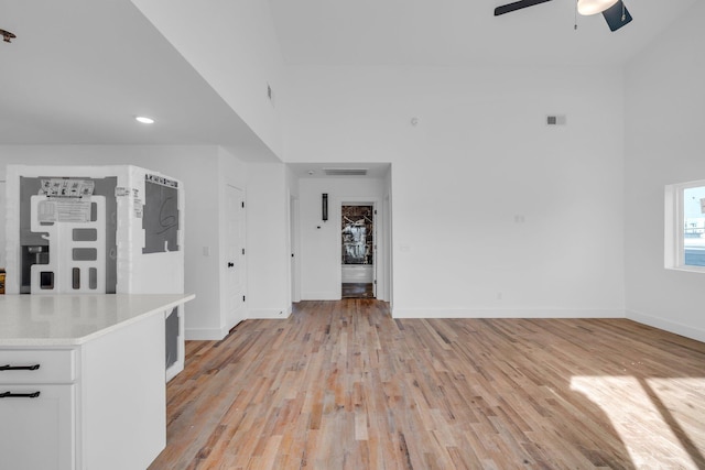 unfurnished living room with ceiling fan and light hardwood / wood-style floors