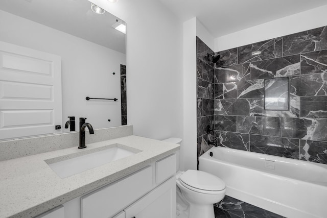 full bathroom with toilet, vanity, and tiled shower / bath