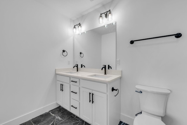 bathroom featuring vanity and toilet