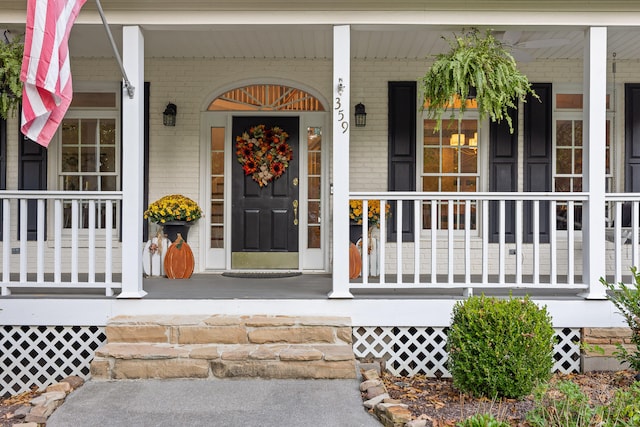 view of exterior entry with covered porch