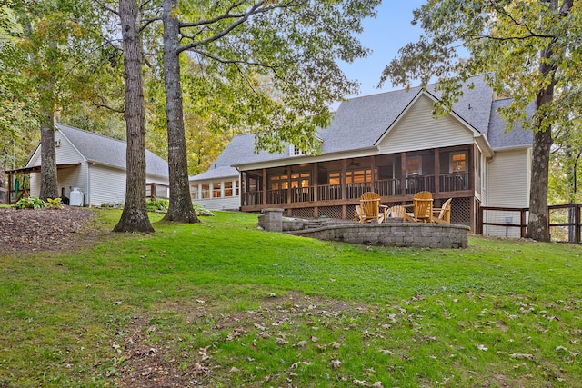 rear view of property with a sunroom and a lawn