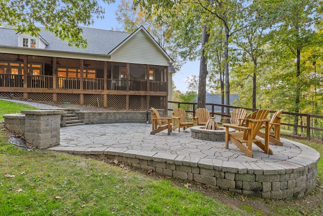 view of patio featuring a sunroom and an outdoor fire pit