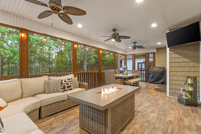 sunroom / solarium featuring a wealth of natural light and ceiling fan