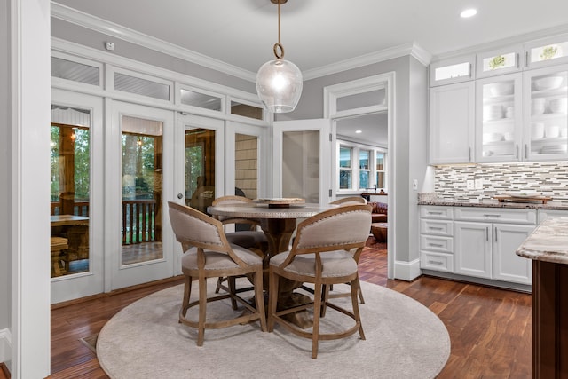 dining space with french doors, dark hardwood / wood-style floors, and ornamental molding