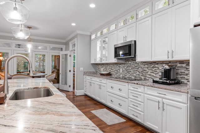 kitchen with pendant lighting, white cabinetry, sink, and appliances with stainless steel finishes