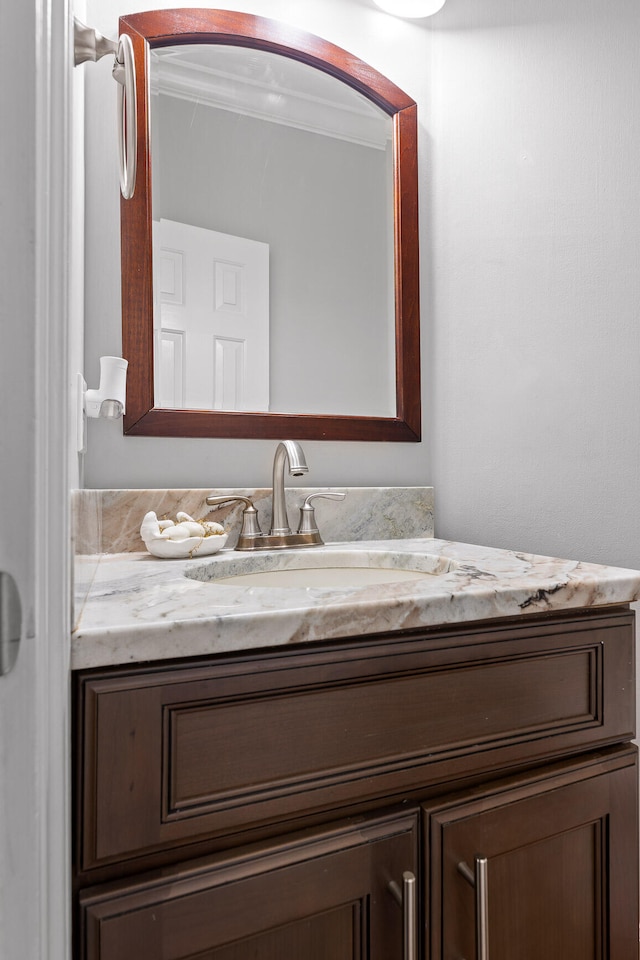 bathroom with vanity and ornamental molding