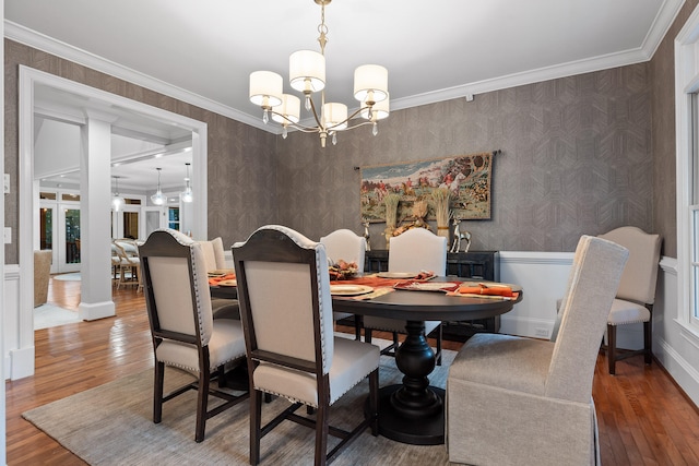 dining area featuring hardwood / wood-style floors, a chandelier, and ornamental molding