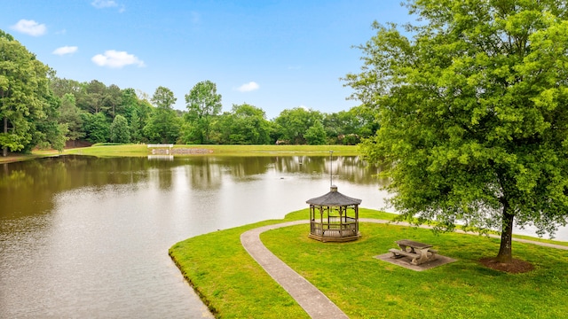 view of community with a gazebo, a lawn, and a water view