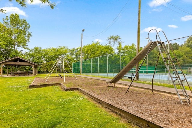 view of play area with a gazebo, a lawn, and tennis court