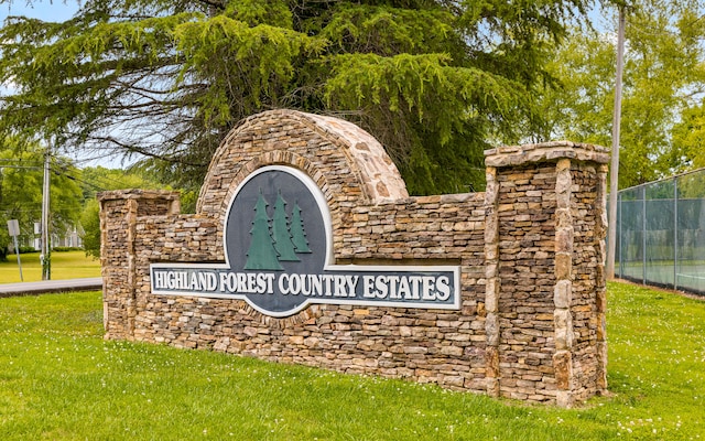 community / neighborhood sign with a lawn