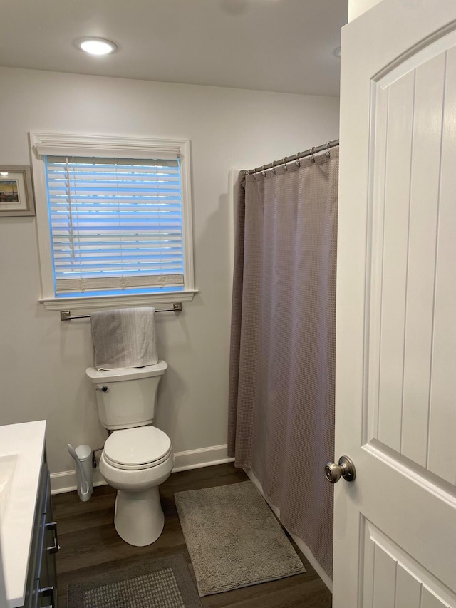 bathroom with vanity, toilet, hardwood / wood-style flooring, and a shower with curtain